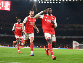 Gunners Invincible Kanu celebrates Arsenal's victory against Manchester United