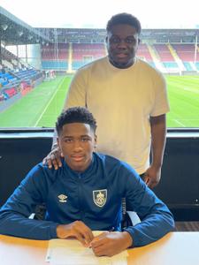 Photo : Nigerian defender completes transfer to Burnley Youth; Huddersfield, Ipswich, Boro miss out