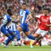 Nigerian CB watches on from the bench as Arsenal